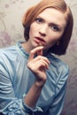 Glamorous red-haired (ginger) girl eating candy