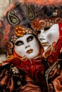 Glamorous and romantic couple with beautiful eyes and venetian mask during venice carnival