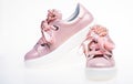Glamorous sneakers concept. Cute shoes on white background. Pair of pale pink female sneakers with velvet