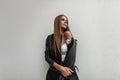 Glamorous stylish young woman in a fashionable leather jacket in a vintage top posing on a white background. Beautiful pretty