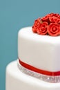 Luxury wedding cake with crystals and red silk ribbon and red roses Royalty Free Stock Photo