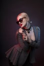 Glamorous woman in chocker and glasses with red studio light