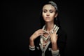 Glamorous woman with lots of jewelry on a black background Royalty Free Stock Photo