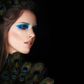 Glamorous Woman with Makeup and Peacock Feathers on Black