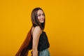 Glamorous young woman with straight hairstyle posing in studio. Indoor shot of relaxed brunette girl  on yellow Royalty Free Stock Photo