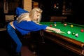 Glamour beautiful blonde woman plays billiard Royalty Free Stock Photo
