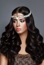 Glamour beauty woman brunette with beautiful shiny gourgeous perfect curly hair and makeup Royalty Free Stock Photo