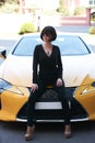 Glamour brunette babe standing near luxury sport car Royalty Free Stock Photo