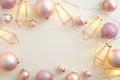 Glamour Christmas composition. Pink Christmas balls decoration with lights garland on white background. Christmas frame. Flat lay