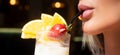 Glamour closeup of womans lips drinking cocktail with straw. Close up female sensual lips and mouth drinking cocktails