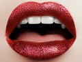 Glamour fashion bright red lips make-up with glitter. Macro of woman`s face part. Sexy glossy lip makeup, luxury lady Royalty Free Stock Photo