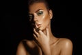 Glamour high contrast young woman with green colors makeup on bl Royalty Free Stock Photo