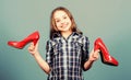 Glamour high heels. Awesome red glossy stiletto shoes. Little fashionista kid with high heels. Wish to grow up faster Royalty Free Stock Photo