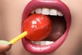 Glamour macro shoot with woman's lips with a sweet bonbon lollipop Royalty Free Stock Photo