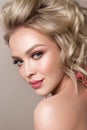 Glamour portrait of beautiful girl model with makeup and romantic wavy hairstyle. Royalty Free Stock Photo