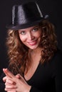 Glamour portret of beauty woman smiling in dark hat with pistol