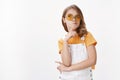 Glamour sassy pretty little fashionable girl with blond hair, wear yellow sunglasses and overalls, pouting smirk