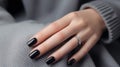 Glamour woman hand with black nail polish on her fingernails. Black nail manicure with gel polish at a luxury beauty salon. Nail