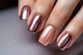 Glamour woman hand with brown nail polish on her fingernails. Beige color nail manicure with gel polish at luxury beauty salon.