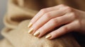 Glamour woman hand with golden nail polish on her fingernails. Golden nail manicure with gel polish at a luxury beauty salon. Nail