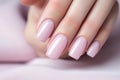 Glamour woman hand with light pink nail polish on her fingernails. Pink nail manicure with gel polish at luxury beauty salon. Nail Royalty Free Stock Photo