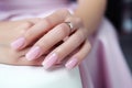 Glamour woman hand with light pink nail polish on her fingernails. Pink nail manicure with gel polish at luxury beauty salon. Nail Royalty Free Stock Photo