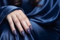 Glamour woman hand with navy blue nail polish on her fingernails. Navy nail manicure with gel polish at luxury beauty salon. Nail