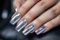 Glamour woman hand with silver nail polish on her fingernails. metallic nail manicure with gel polish at luxury beauty salon. Nail Royalty Free Stock Photo