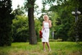 glamour woman with a red rose. Outdoor summer picture Royalty Free Stock Photo