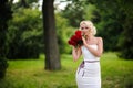 glamour woman with a red rose. Outdoor summer picture Royalty Free Stock Photo