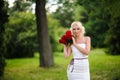 glamour woman with a red rose. Outdoor summer picture Royalty Free Stock Photo