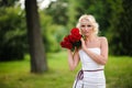 glamour woman with a red rose. Outdoor summer picture Royalty Free Stock Photo
