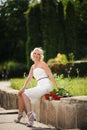 glamour woman with a red rose. Outdoor summer picture Royalty Free Stock Photo