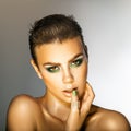 Glamour young woman with green colors makeup looking at camera i Royalty Free Stock Photo