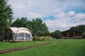 Glamping Dome and Wooden Cabin in Countryside Royalty Free Stock Photo