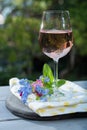 Glas of cold rose wine, outdoor terrase, sunny day, spring garden flowers Royalty Free Stock Photo