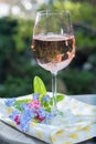 Glas of cold rose wine, outdoor terrase, sunny day, spring garden flowers Royalty Free Stock Photo