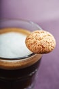 Glas of espresso macchiato with cookies. Close up.