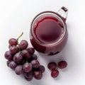 a glas jar with grape juice surrounded by red grapes