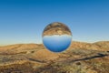 single glas sphere ball hovering in the air in large empty desert environment abstract surreal concept 3D Illustration