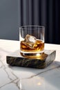 a glas of whiskey with an icecube on a stone coaster