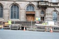 Exterior of building with workmen errecting scaffolding inside a safety area.  Old building Royalty Free Stock Photo