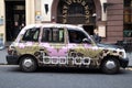 Exterior shot of Boohoo clothing advert as a wrap on black cab taxi Royalty Free Stock Photo