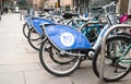 Nextbike bicycle rental bikes on stand mixed with privately owned bike on street Royalty Free Stock Photo