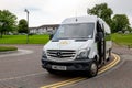 Mercedes-Benz Sprinter touristic shuttle bus of the Escocia Turismo company in the Glasgow Green park Royalty Free Stock Photo