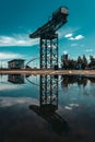 Glasgow Scotland June 2021 Glasgow finnieston crane reflection in water with blue skies on summer day