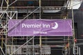 Temporary banner entrance sign for Premiere Inn on building with scaffolding for renovations