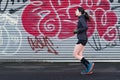 Single woman running in urban environment