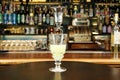 Glass with absinth on bar counter close-up. Royalty Free Stock Photo