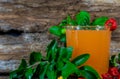 Glass of acerola juice (Malpighia emarginata) on aged wooden background